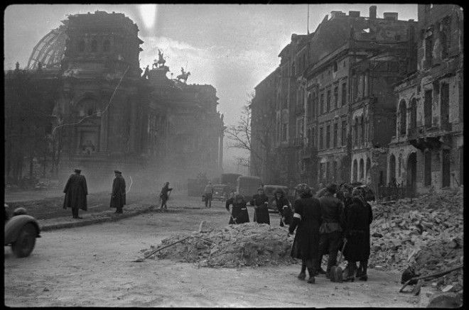 Расчистка местными жителями и военнопленными улиц города у стен Рейхстага. Германия, Берлин, май, 1945 год.